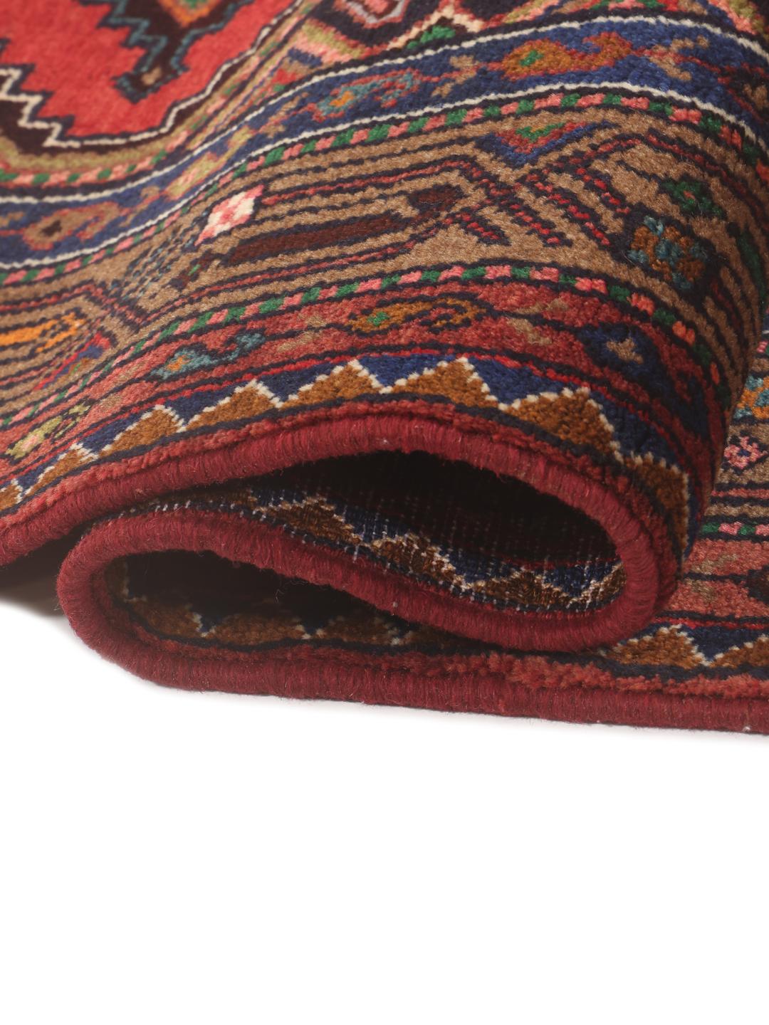 Hand-knotted wool runner rug from the Middle East in dark-red with geometric patterns