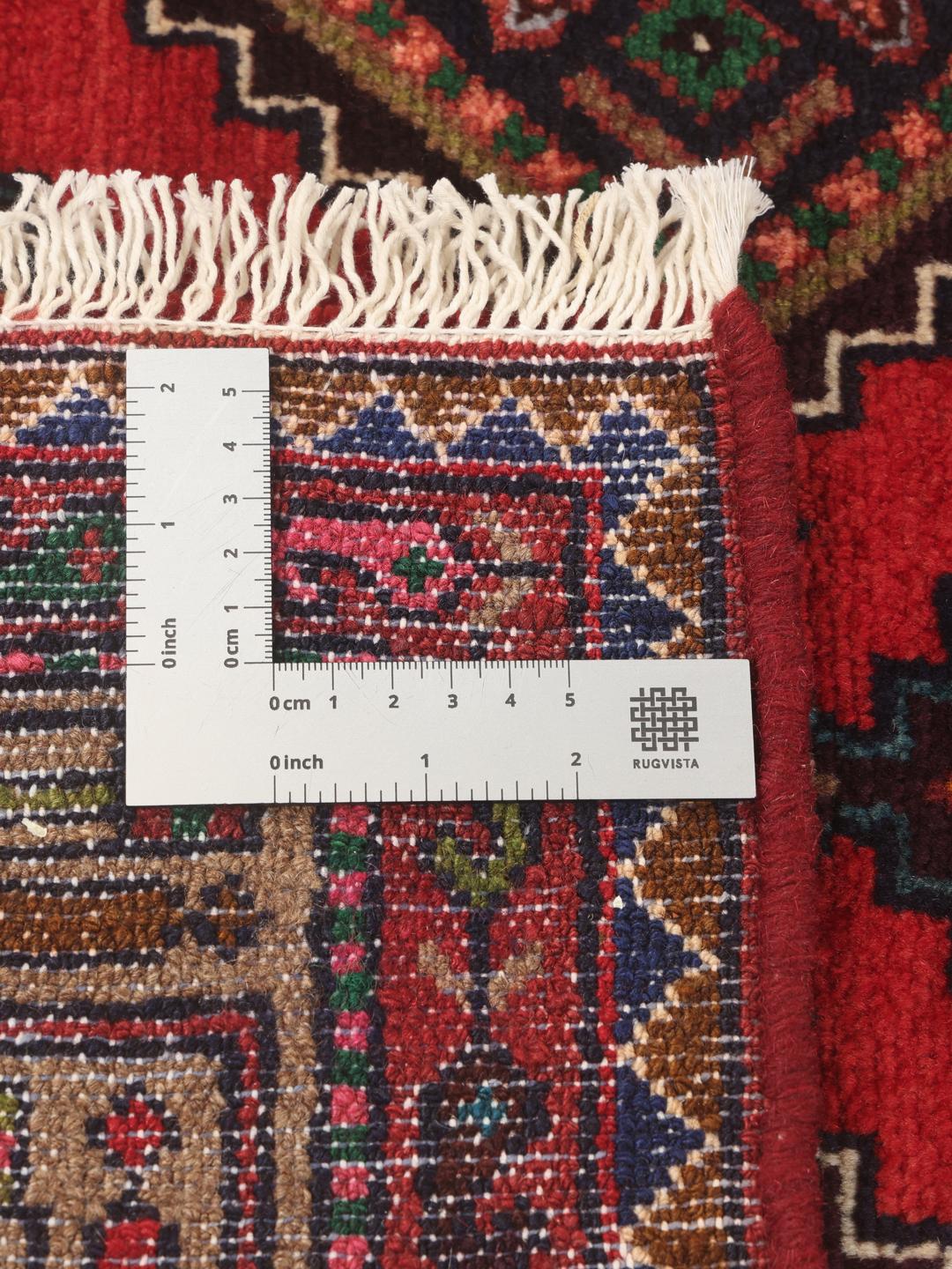 Hand-knotted wool runner rug from the Middle East in dark-red with geometric patterns