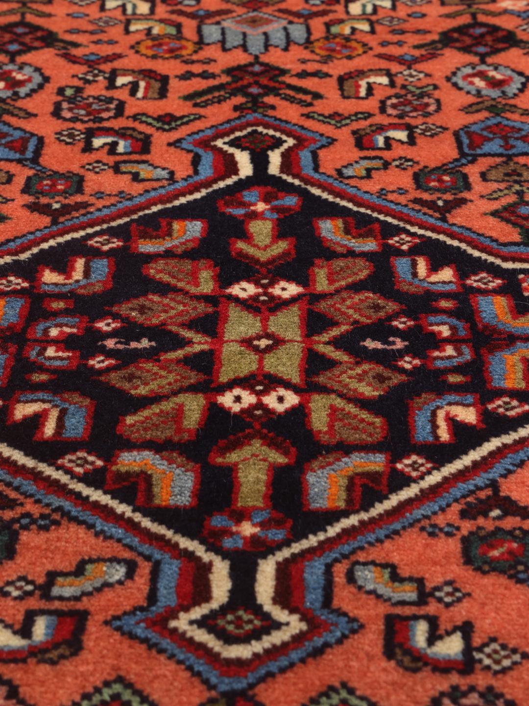 Hand-knotted Middle Eastern runner in red with geometric medallions