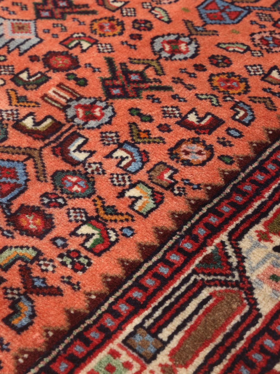 Hand-knotted Middle Eastern runner in red with geometric medallions