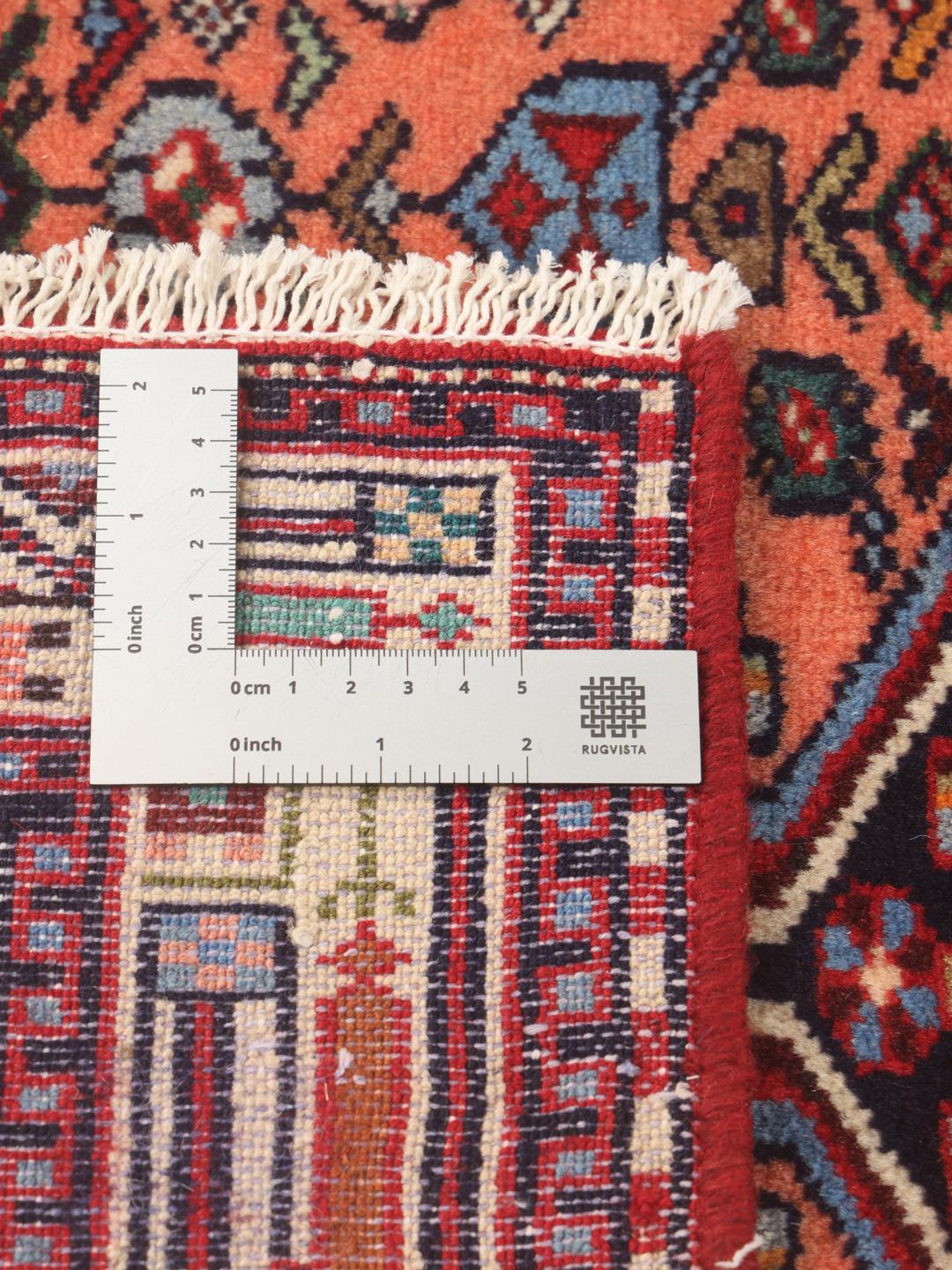 Hand-knotted Middle Eastern runner in red with geometric medallions