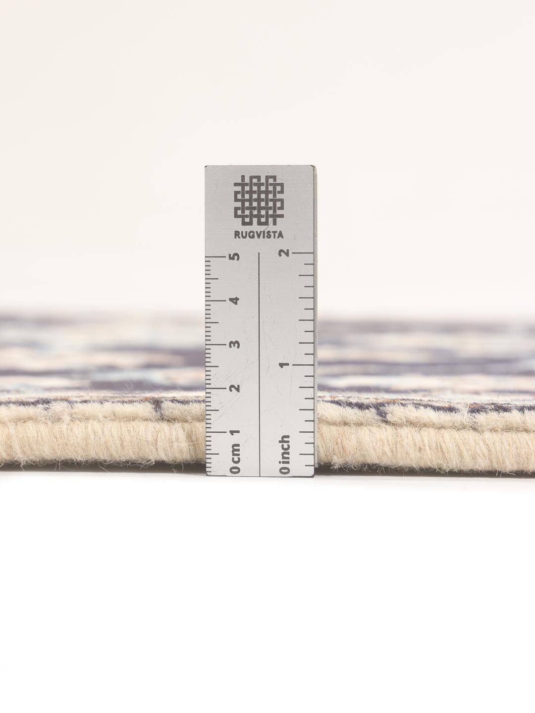 Hand-knotted Nain runner with floral patterns in dark blue and beige tones