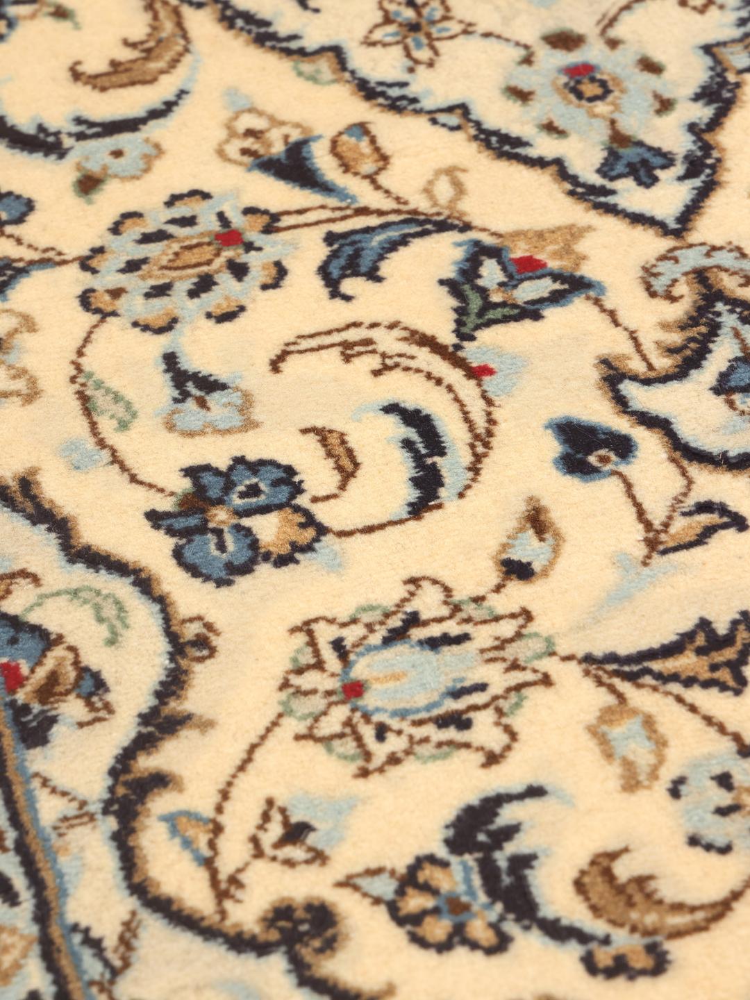 A sophisticated Keshan runner with intricate floral patterns in beige and blue from the Middle East.