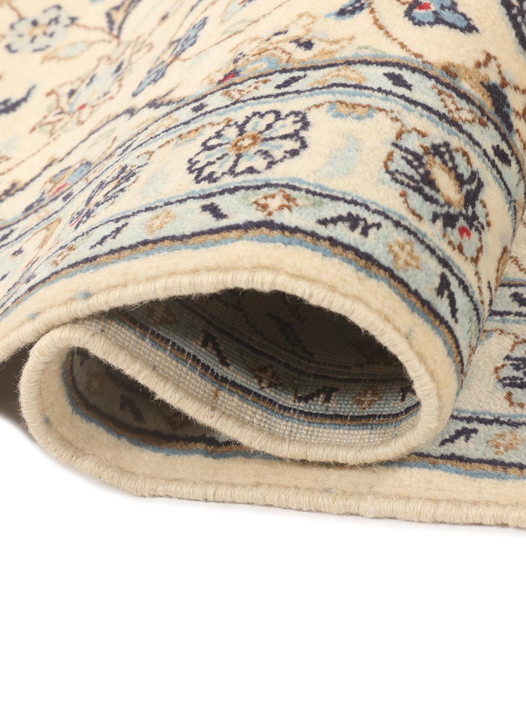 A sophisticated Keshan runner with intricate floral patterns in beige and blue from the Middle East.