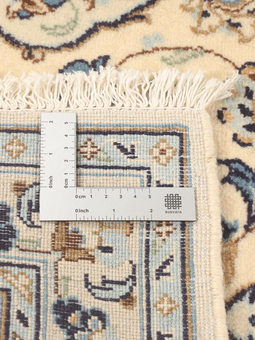A sophisticated Keshan runner with intricate floral patterns in beige and blue from the Middle East.