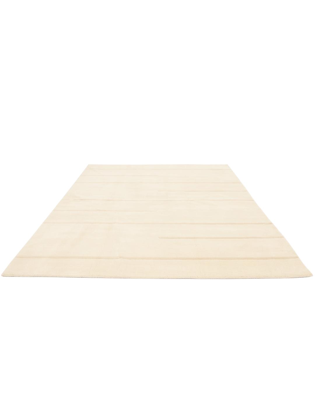 A minimalist beige hand-loomed rug from India featuring clean horizontal lines.