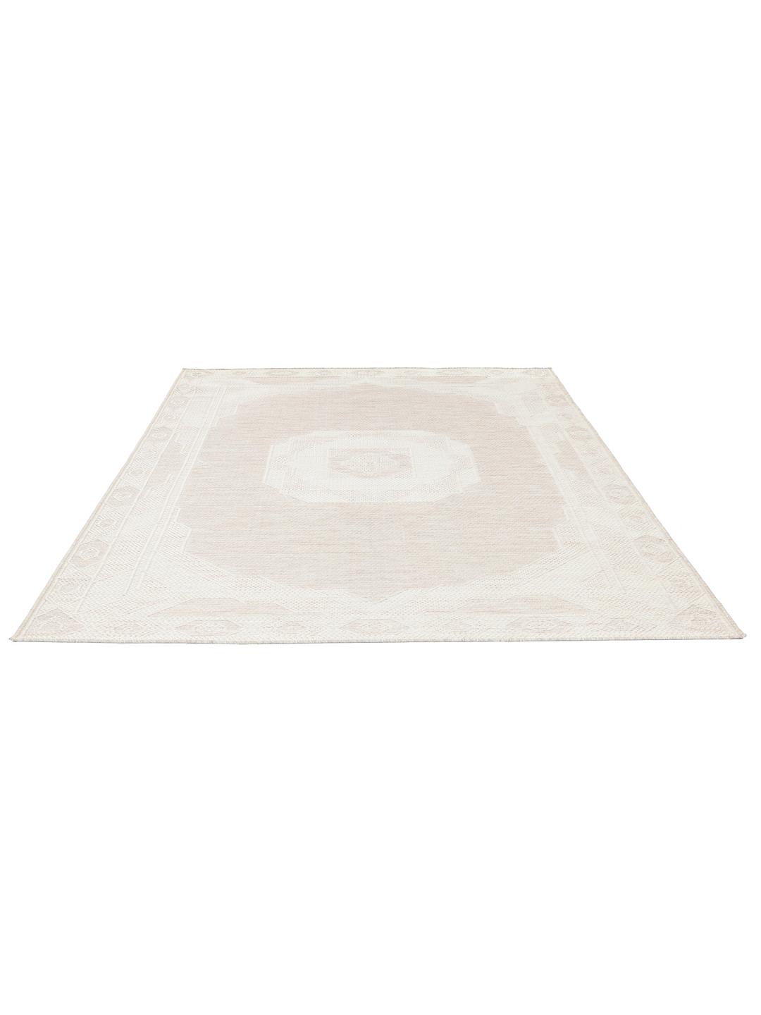 Tapis beige et blanc avec un motif de bordure géométrique