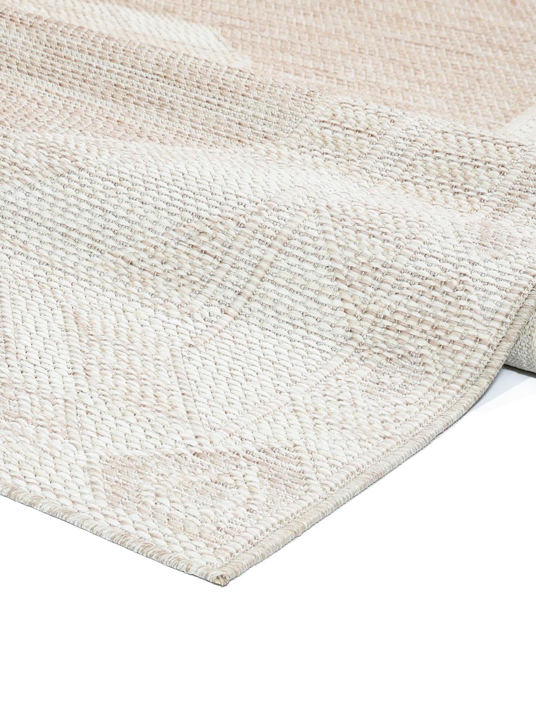 Tapis beige et blanc avec un motif de bordure géométrique