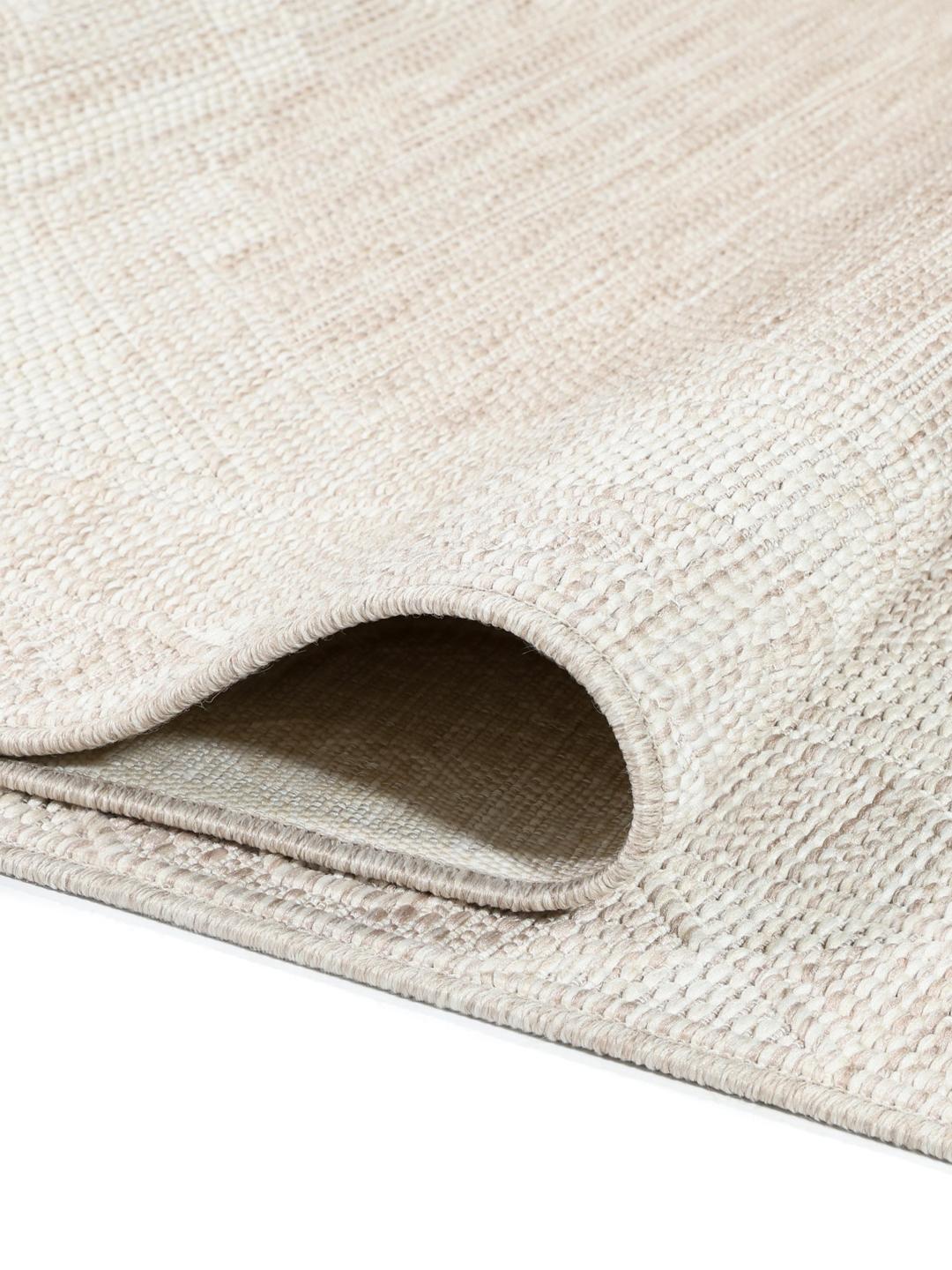Tapis beige et blanc avec un motif de bordure géométrique