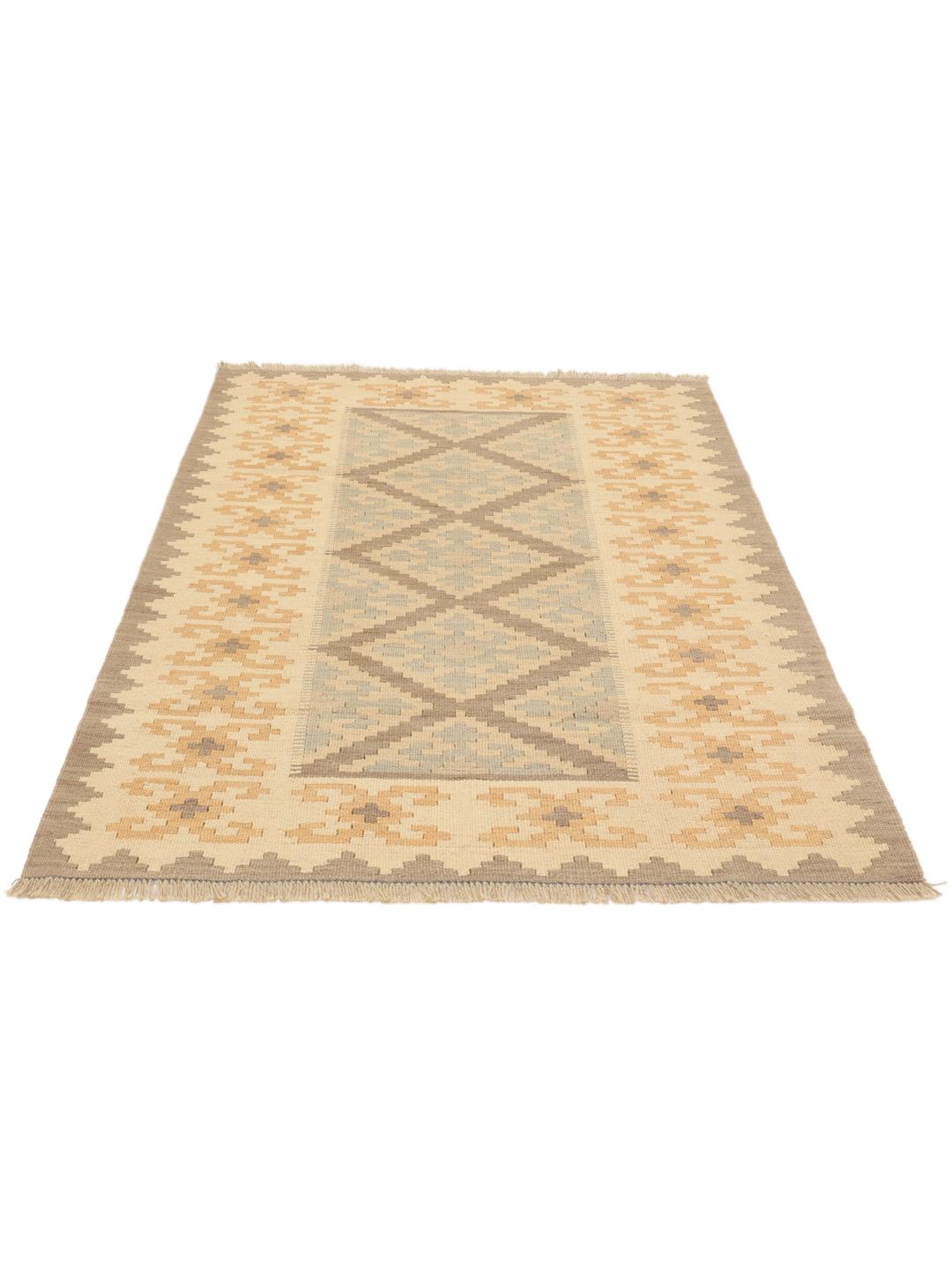 Tappeto kelim Ghashghai tessuto a mano con motivi geometrici a rombi in toni di beige, marrone e blu.