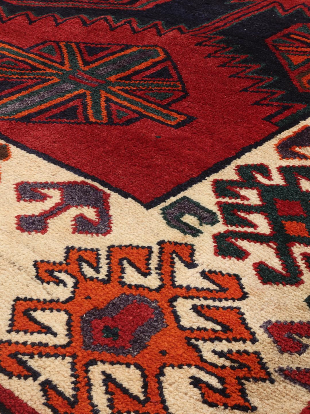 Hand-knotted Lori rug from the Middle East with a red and dark-blue geometric design.