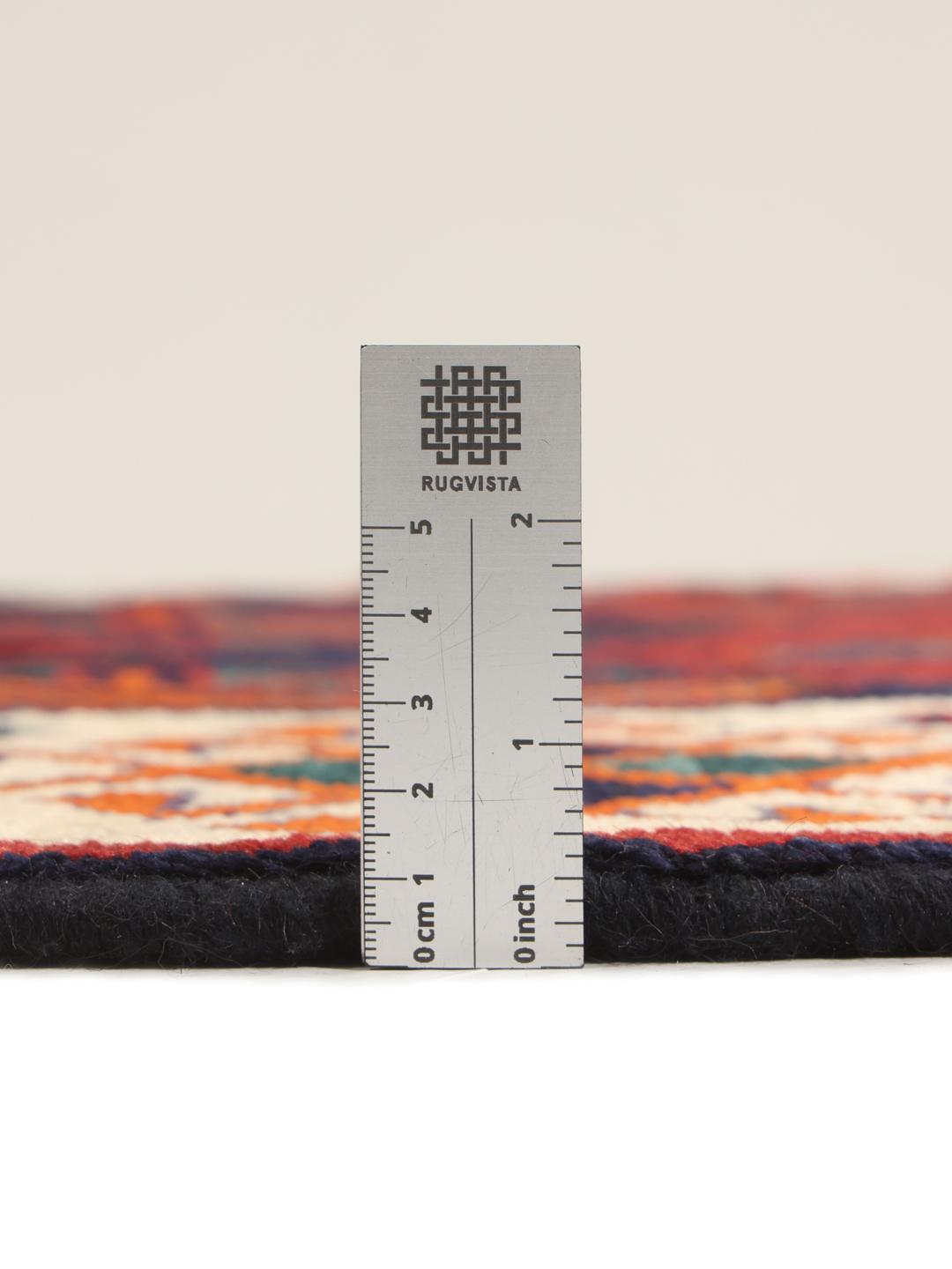Hand-knotted Lori rug from the Middle East with a red and dark-blue geometric design.