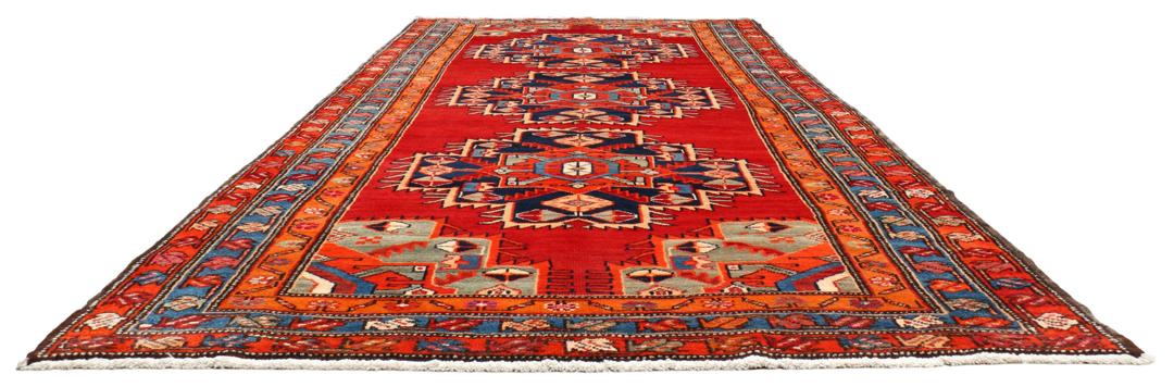 Met de hand geknoopte loper uit het Midden-Oosten in rood met geometrische medaillons