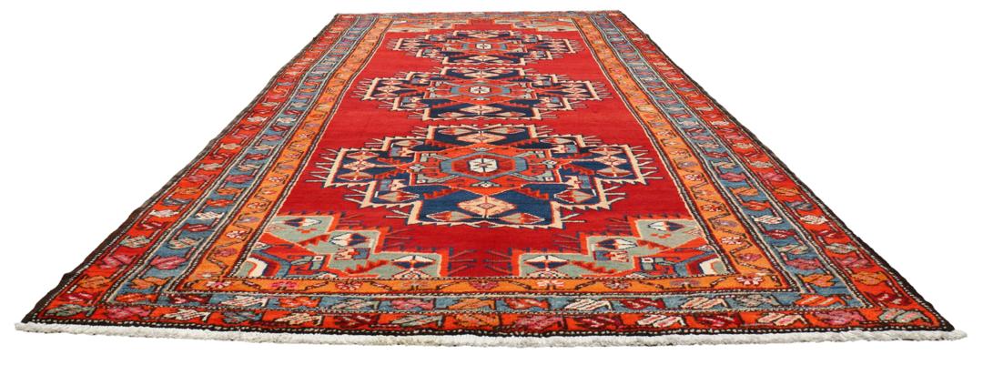 Met de hand geknoopte loper uit het Midden-Oosten in rood met geometrische medaillons