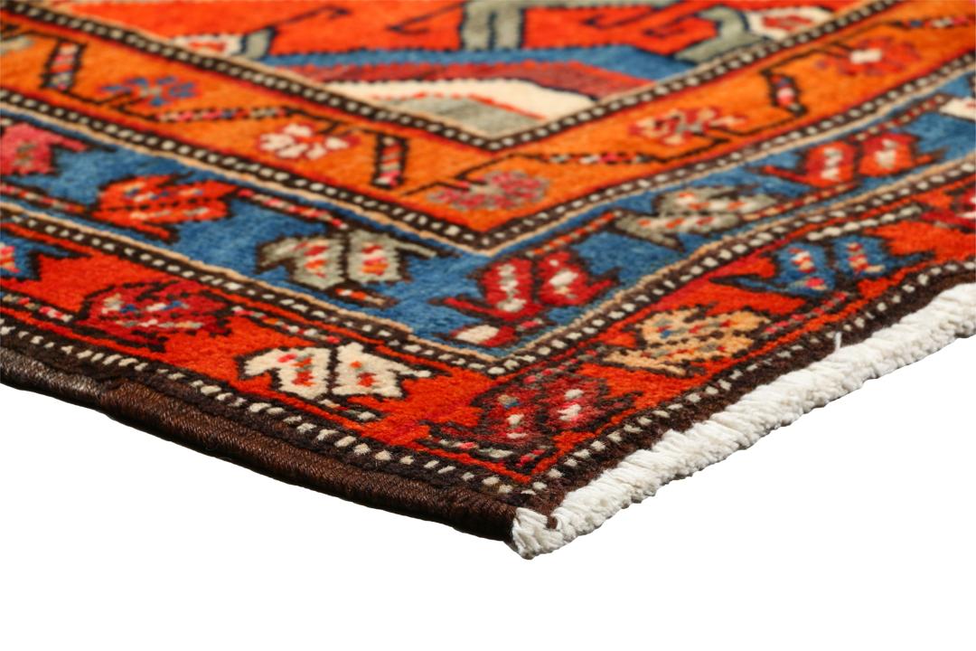 Met de hand geknoopte loper uit het Midden-Oosten in rood met geometrische medaillons