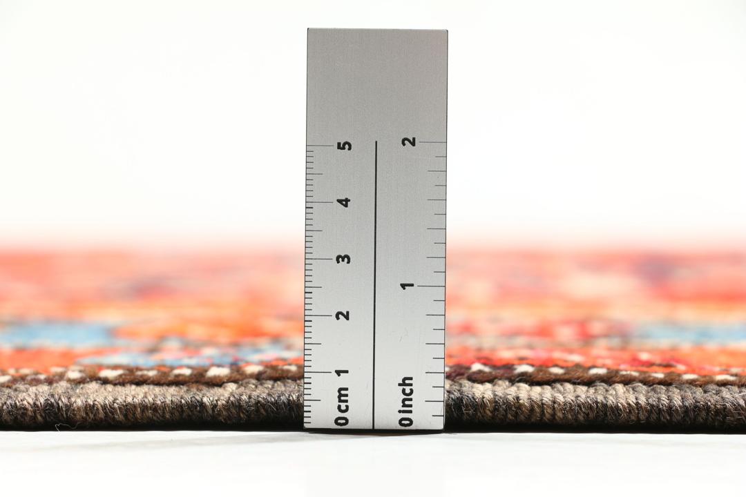 Met de hand geknoopte loper uit het Midden-Oosten in rood met geometrische medaillons