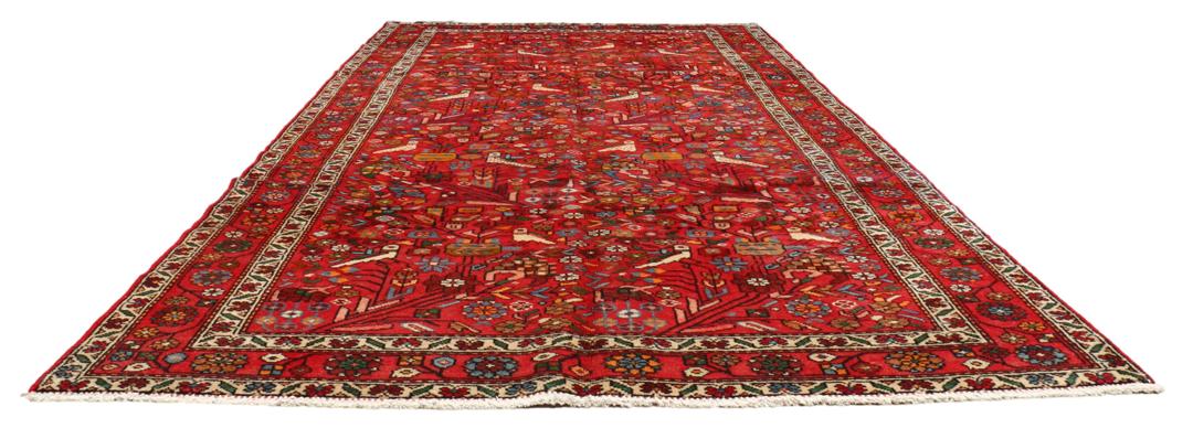 A hand-knotted Hamadan rug from the Middle East with a vibrant red field and bird motifs.