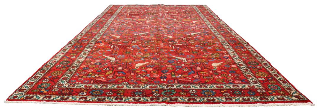A hand-knotted Hamadan rug from the Middle East with a vibrant red field and bird motifs.