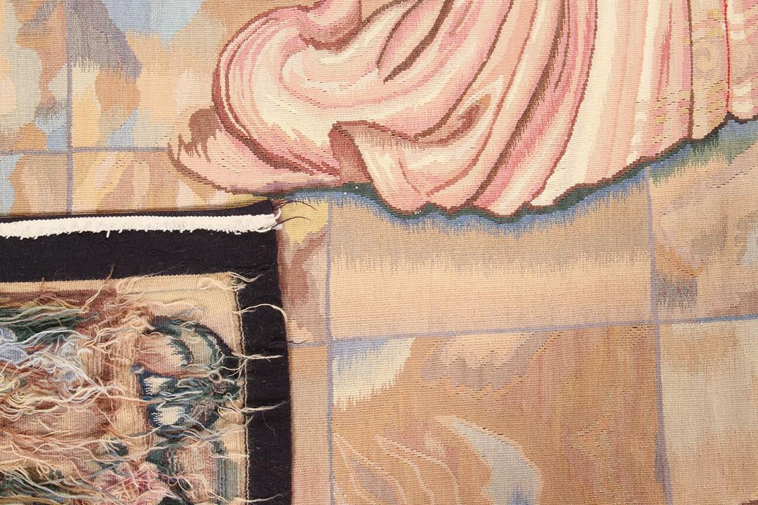 Et rektangulært håndvævet gobelintæppe fra Kina med en flerfarvet historisk scene og blomsterbort
