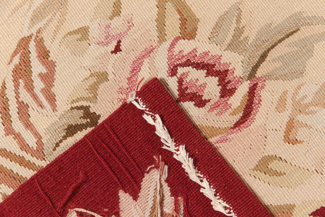 Hand-woven Aubusson-style kilim rug from China with a red and beige floral medallion design
