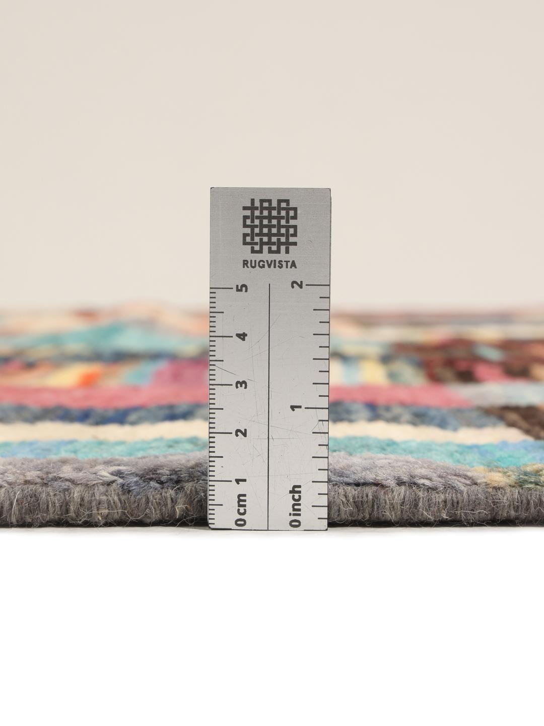 A vibrant, multicoloured, hand-knotted Afghan rug featuring a geometric block pattern.