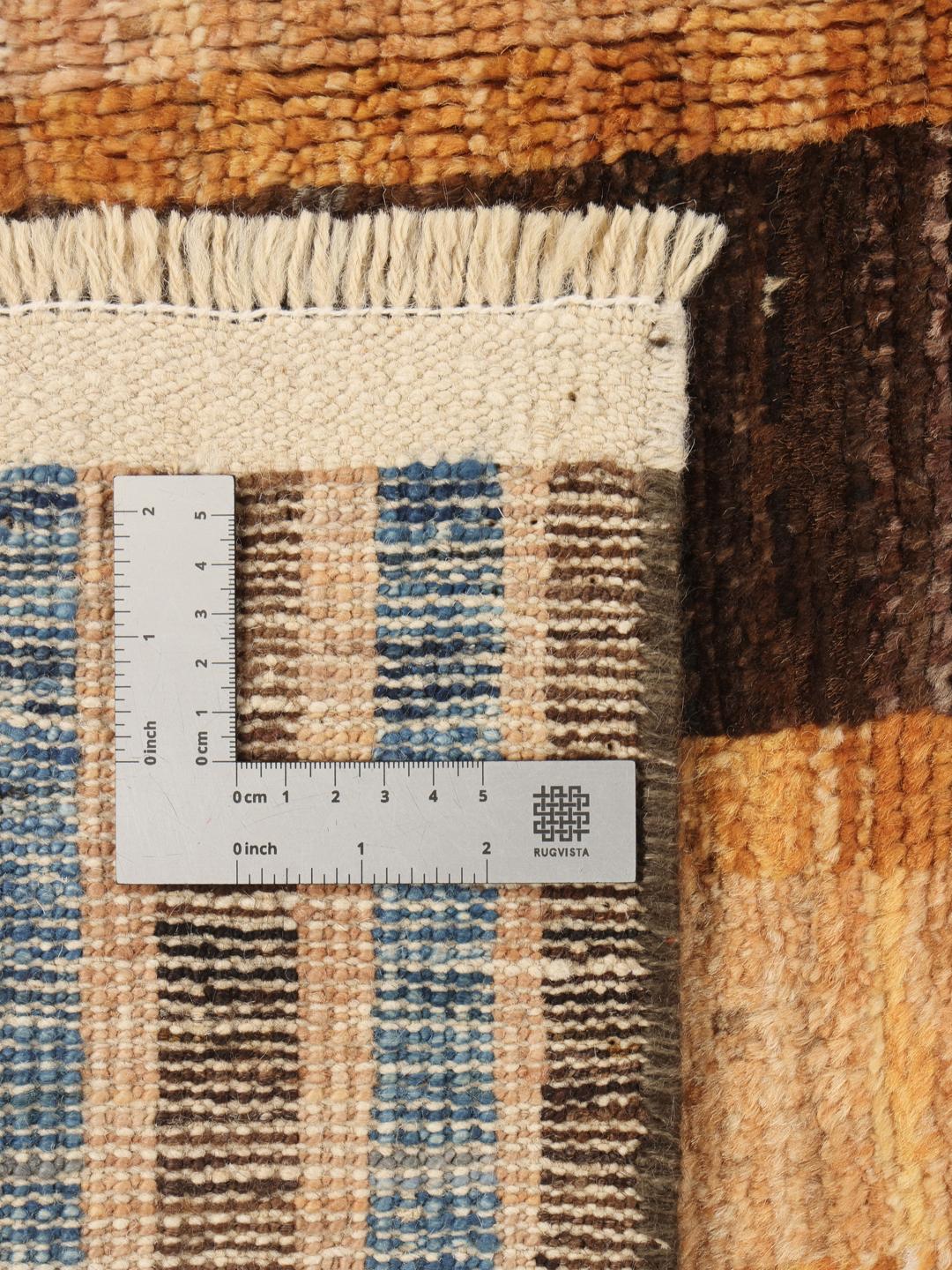 A vibrant, multicoloured, hand-knotted Afghan rug featuring a geometric block pattern.