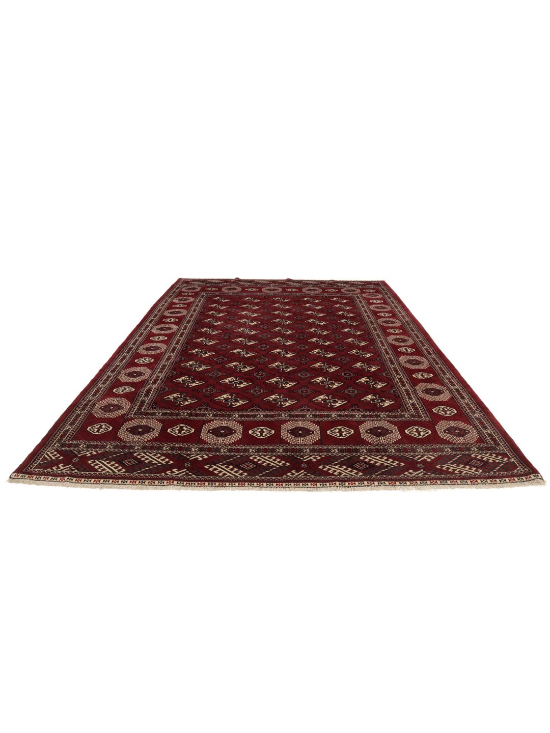 A hand-knotted Middle Eastern Turkman rug featuring deep red tones and geometric patterns.