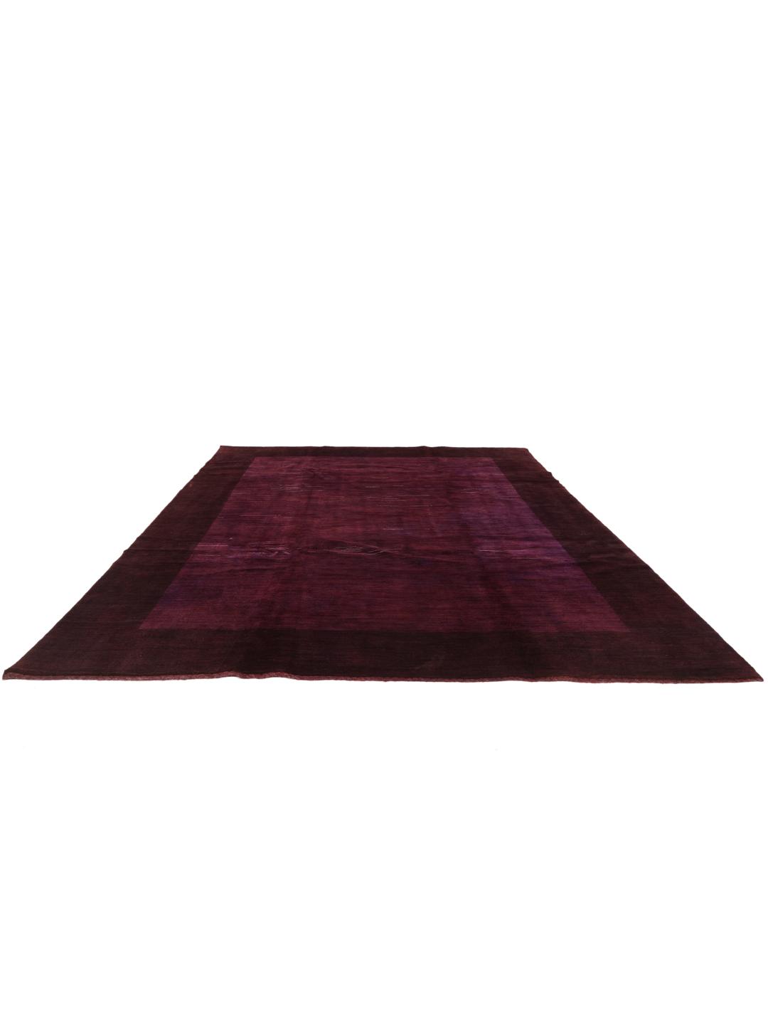 A hand-knotted Gabbeh Fine rug from the Middle East in deep purple tones.