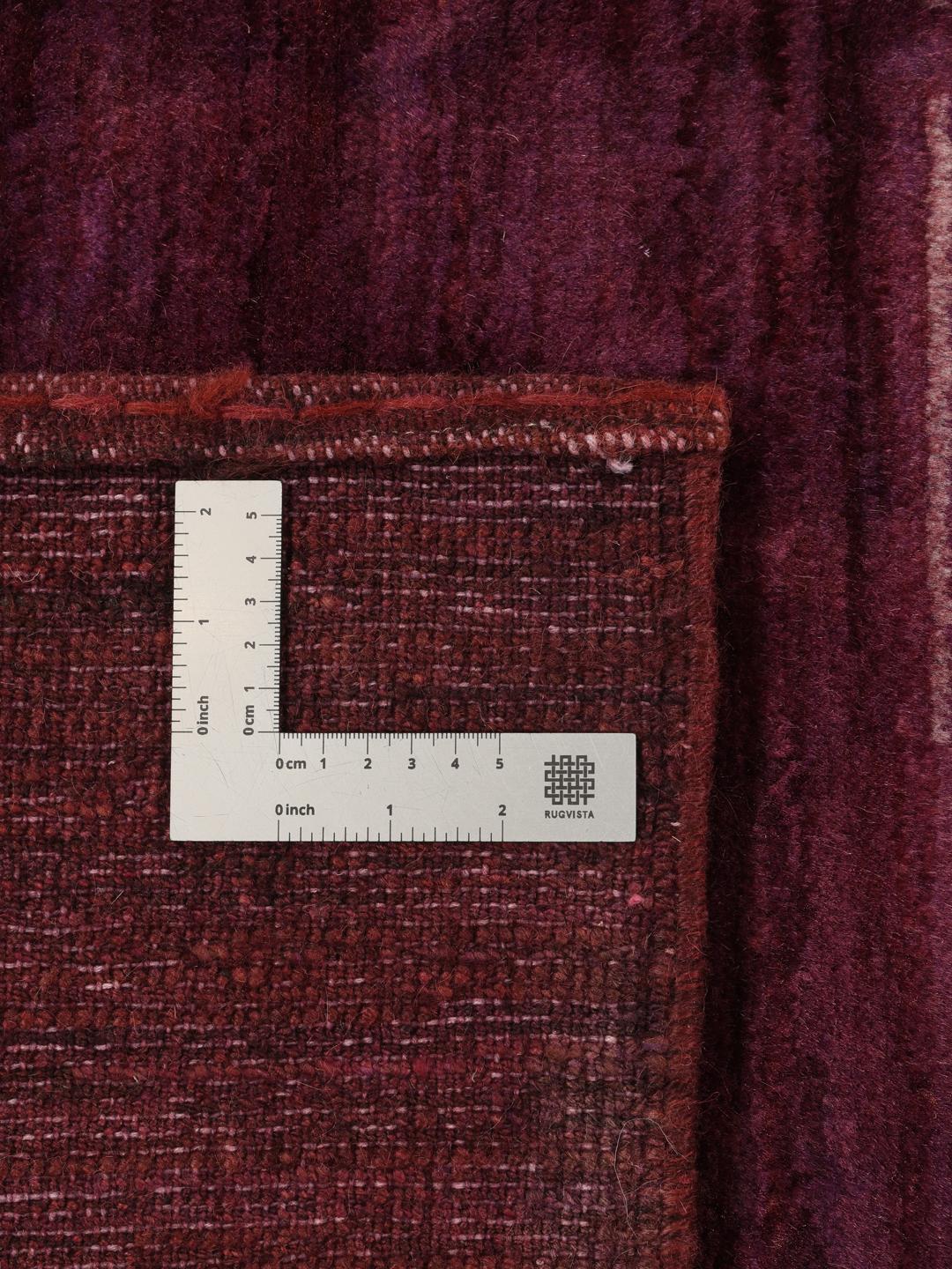 A hand-knotted Gabbeh Fine rug from the Middle East in deep purple tones.