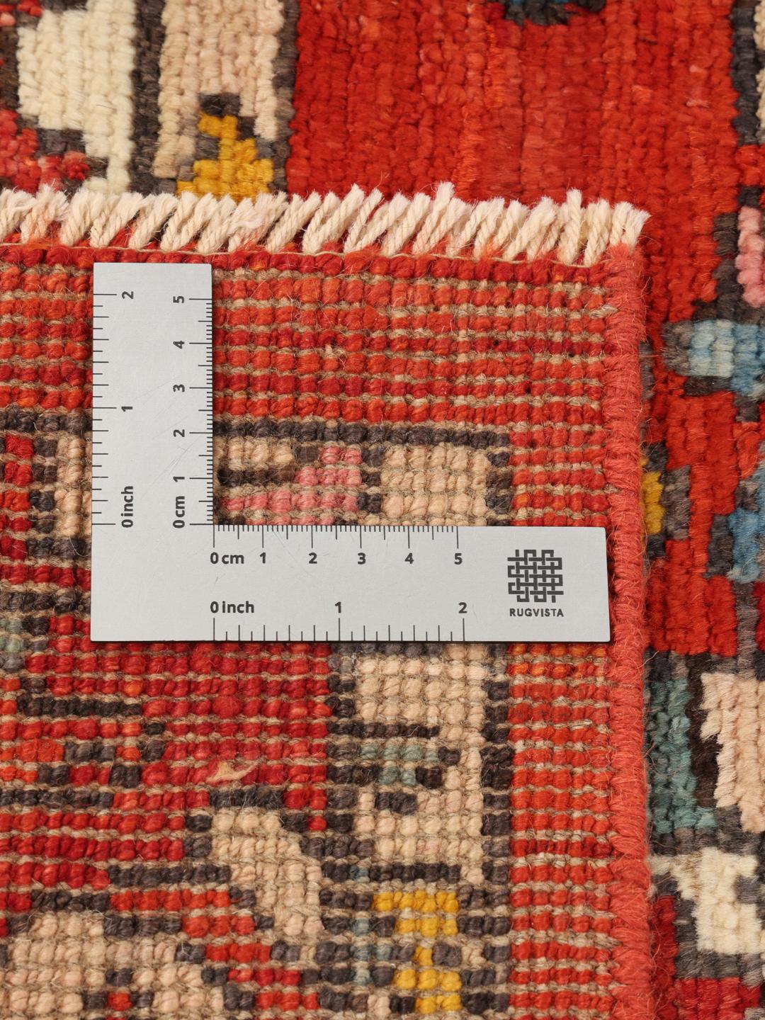 Tapis Kazak afghan noué à la main avec un design géométrique vibrant et des tons bleu et rouge.