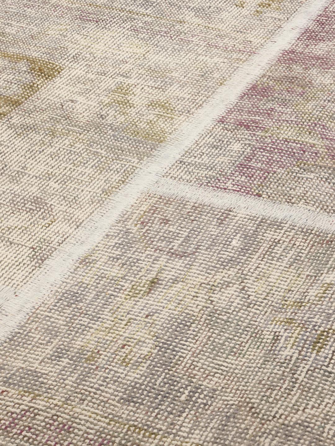 A rectangular handmade patchwork rug from the Middle East featuring a multicolor palette.