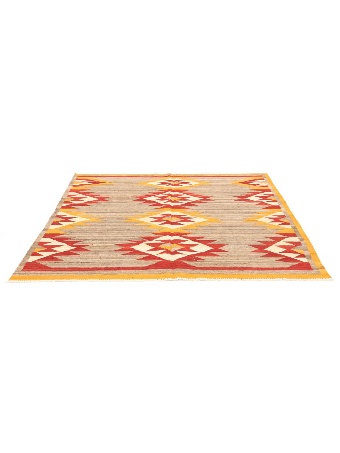 Hand-woven Afghan kilim rug with vibrant geometric patterns in red, yellow, and beige.