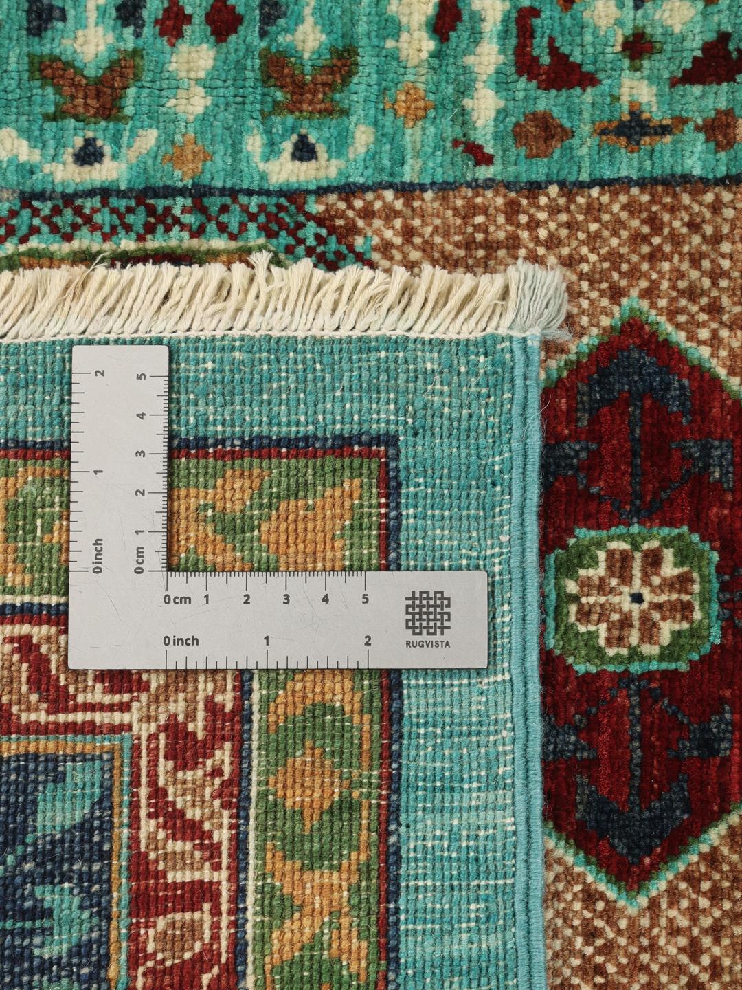 Et håndknyttet Mamluk-tæppe fra Afghanistan med dybblå og røde geometriske motiver.
