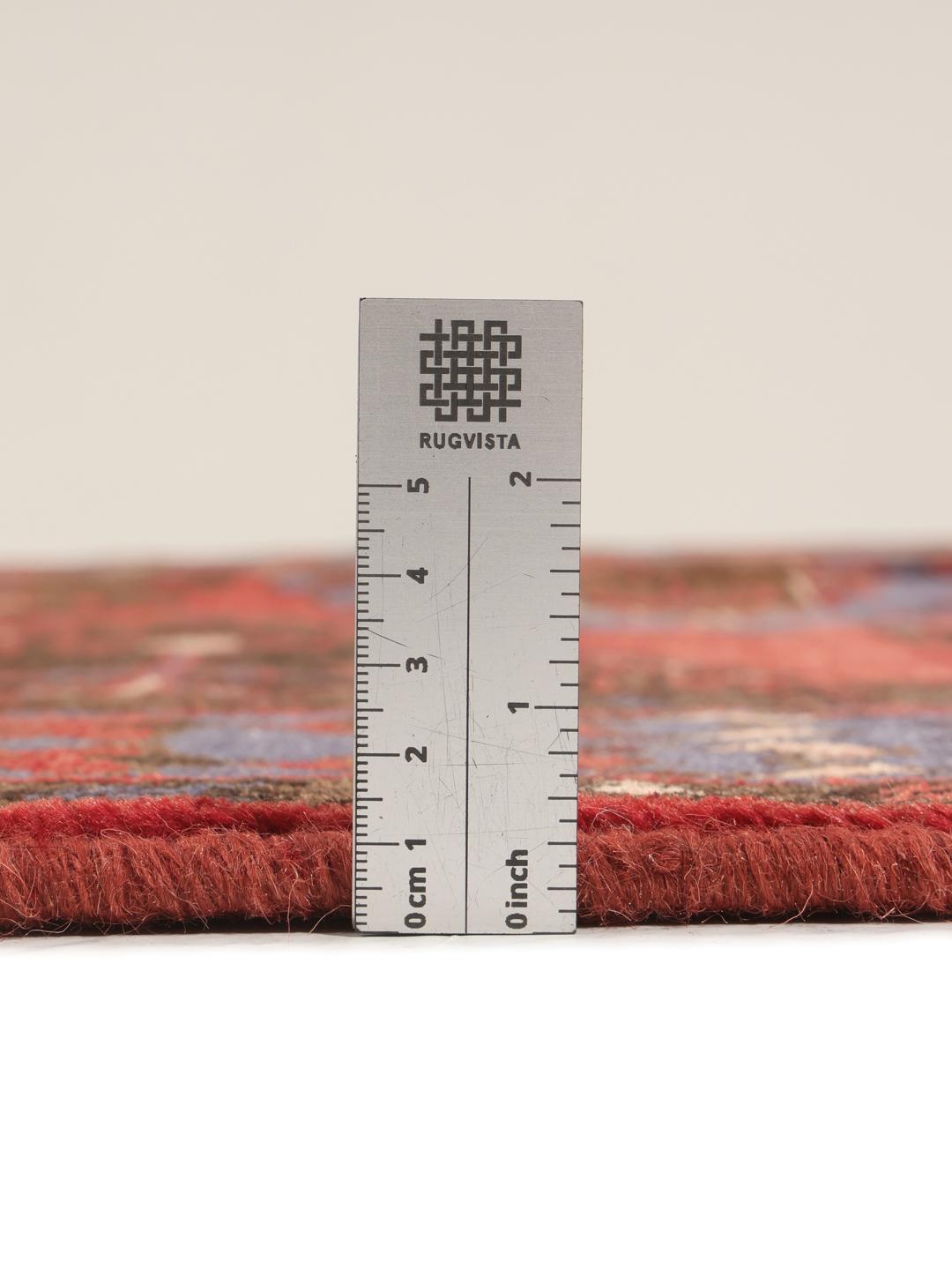Handgeknoopt Wiss-tapijt met een traditioneel rood en blauw geometrisch patroon