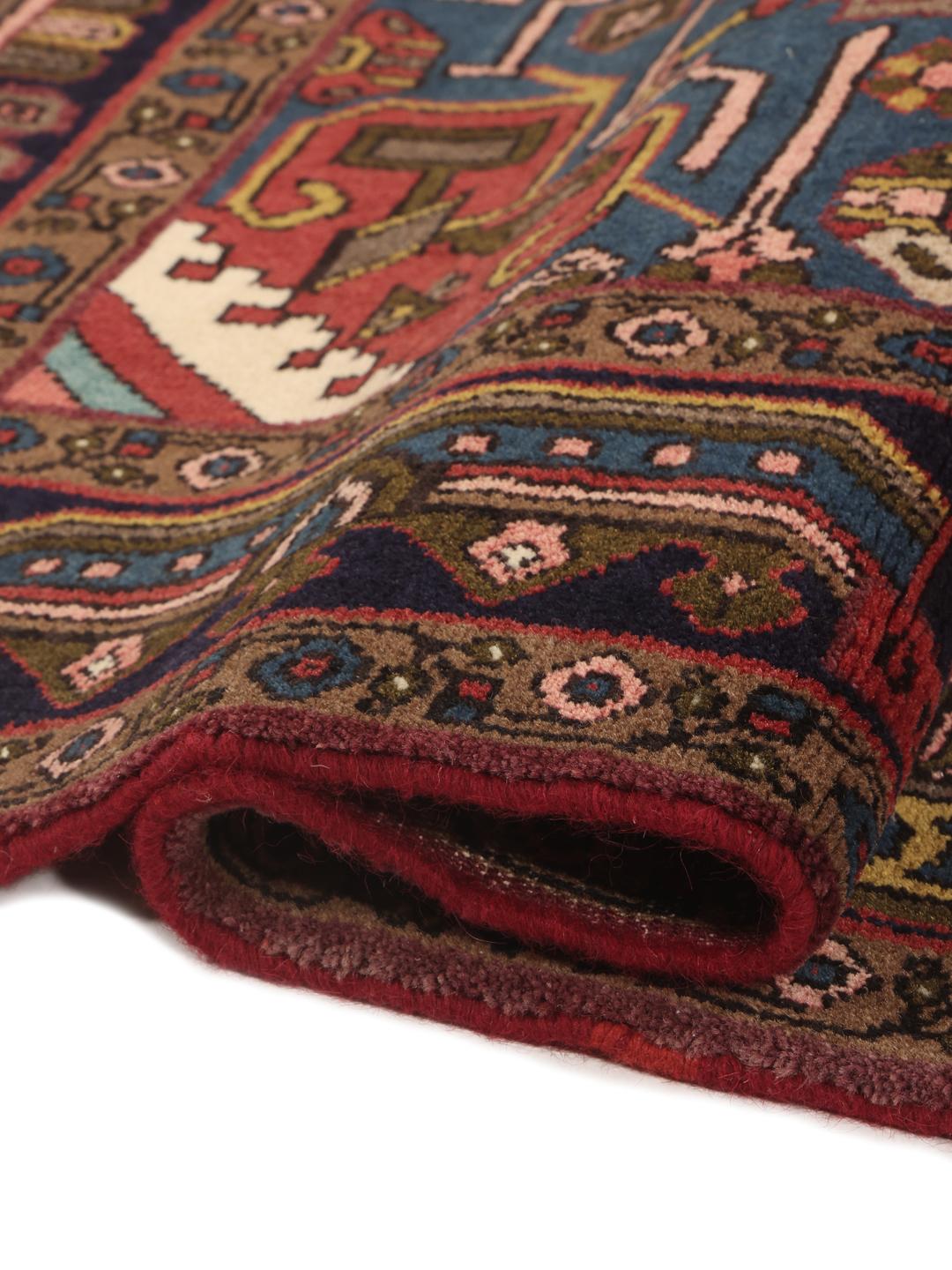Hand-knotted Hosseinabad rug with a central medallion in red and blue tones
