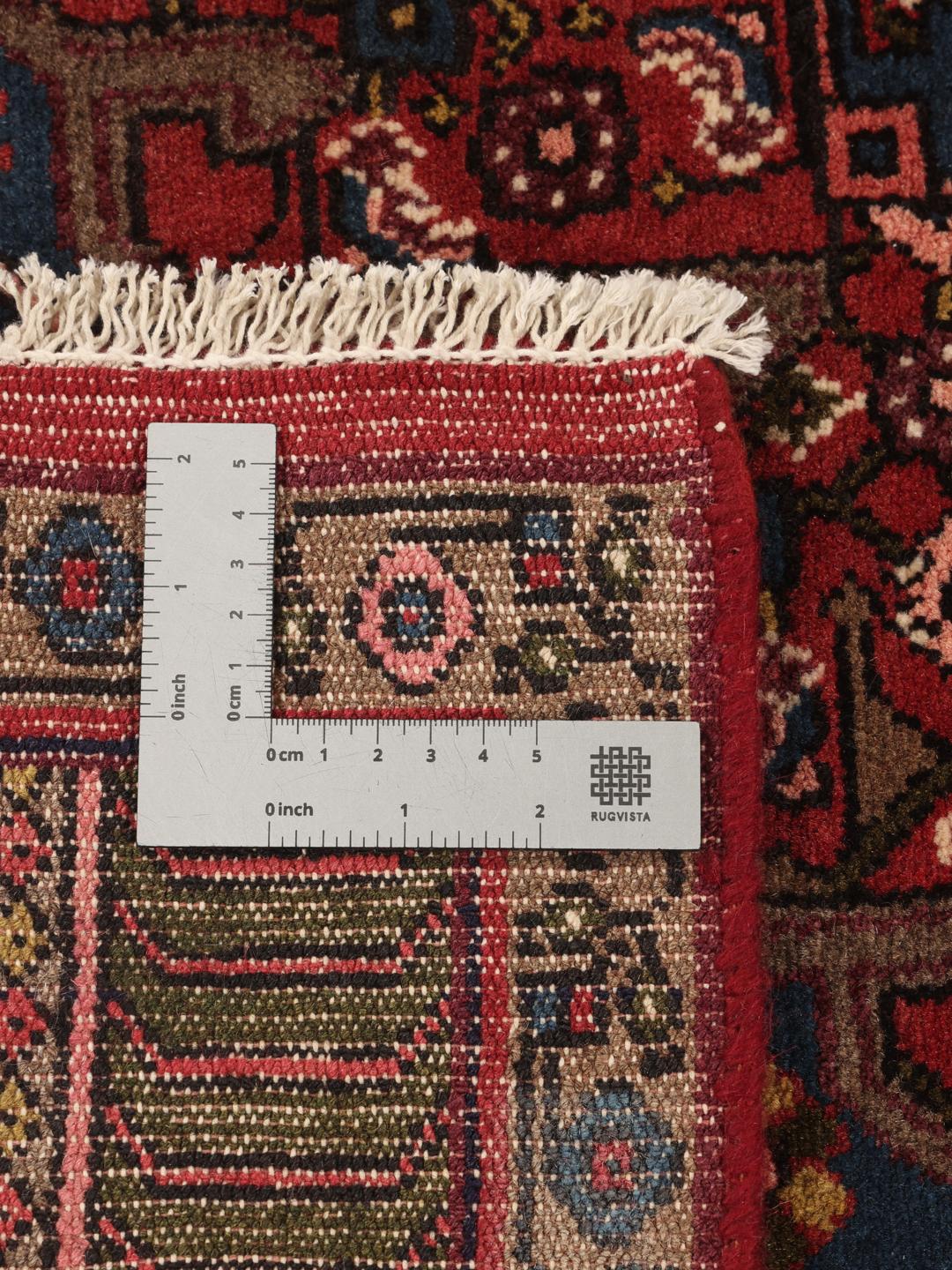 Hand-knotted Hosseinabad rug with a central medallion in red and blue tones