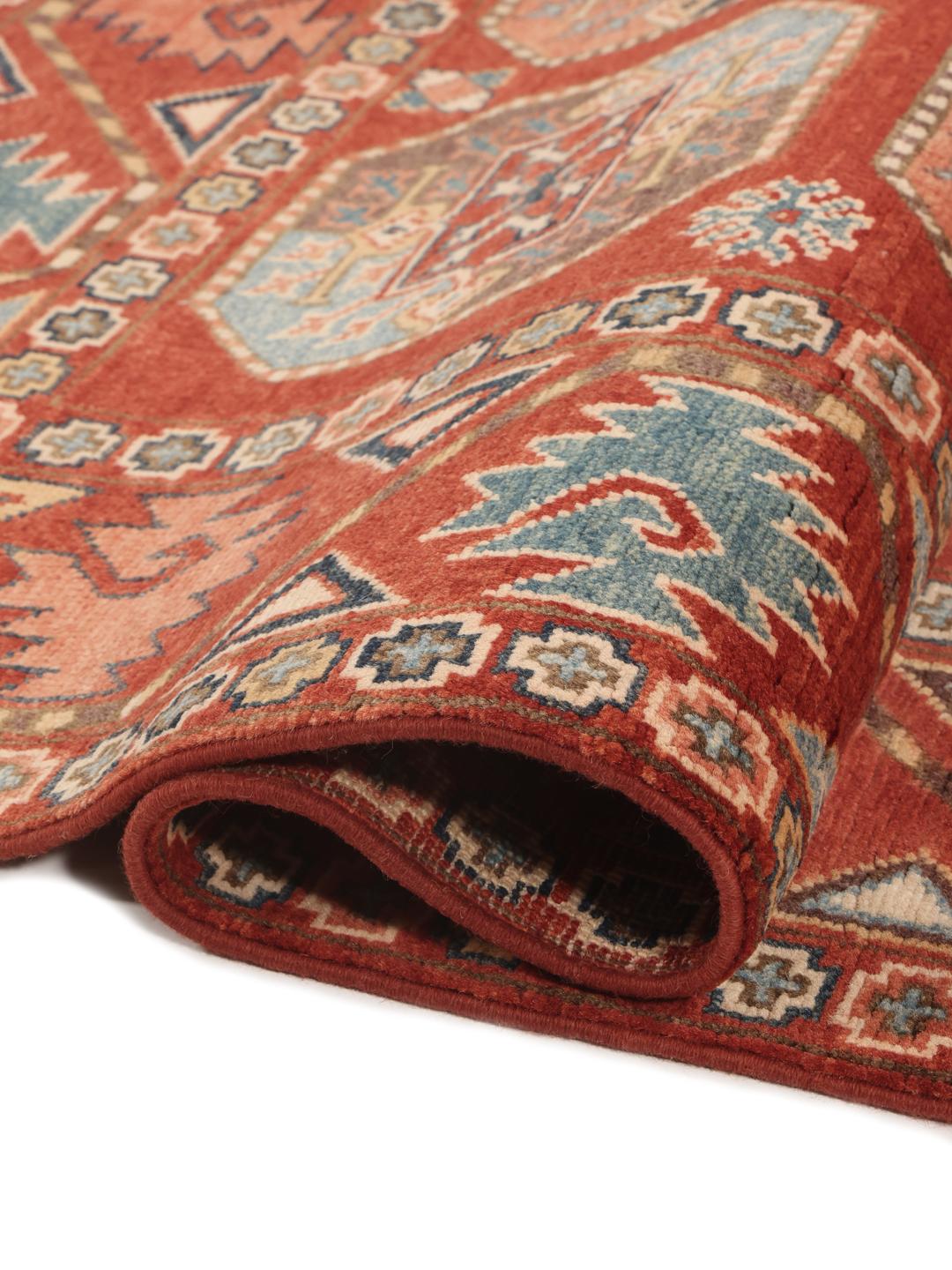 A hand-knotted Kazak rug from Afghanistan in deep red with geometric medallion motifs.