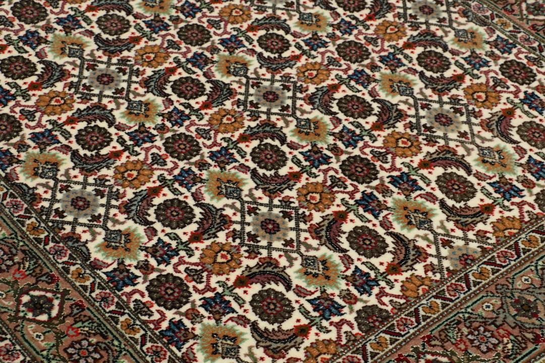 Handgeknoopte Tabriz loper met verfijnde bloemmotieven in meerkleurige tinten.