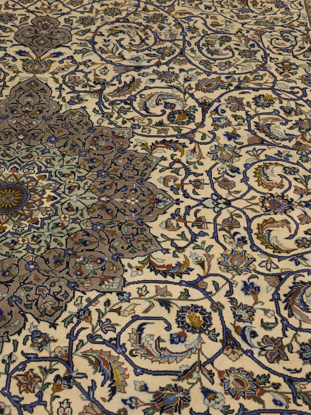 Hand-knotted Keshan rug from the Middle East with an ornate floral pattern in beige and blue tones