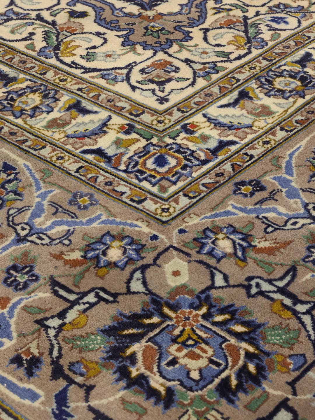 Hand-knotted Keshan rug from the Middle East with an ornate floral pattern in beige and blue tones