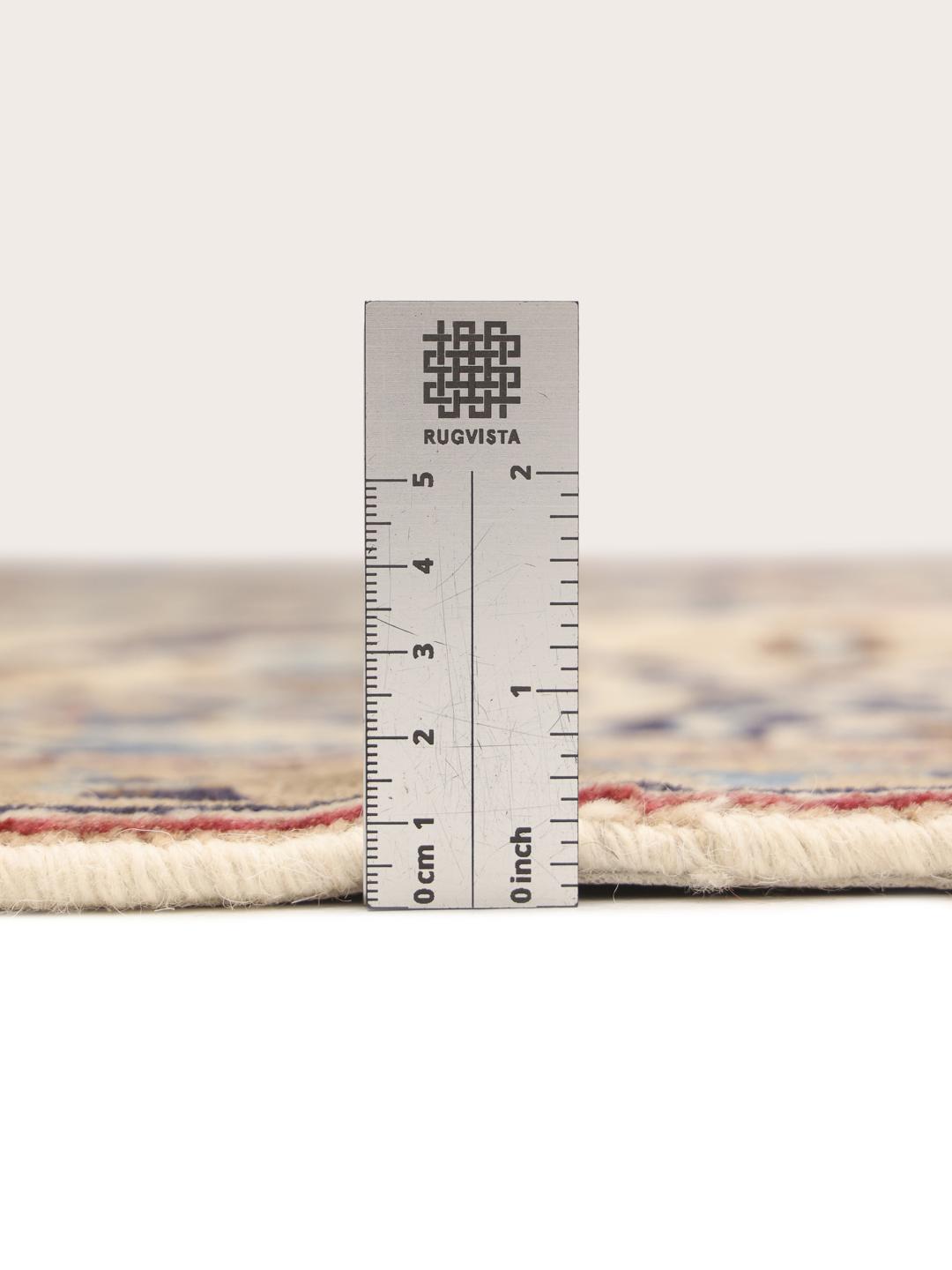 Hand-knotted Middle Eastern rug with intricate floral patterns in beige and blue