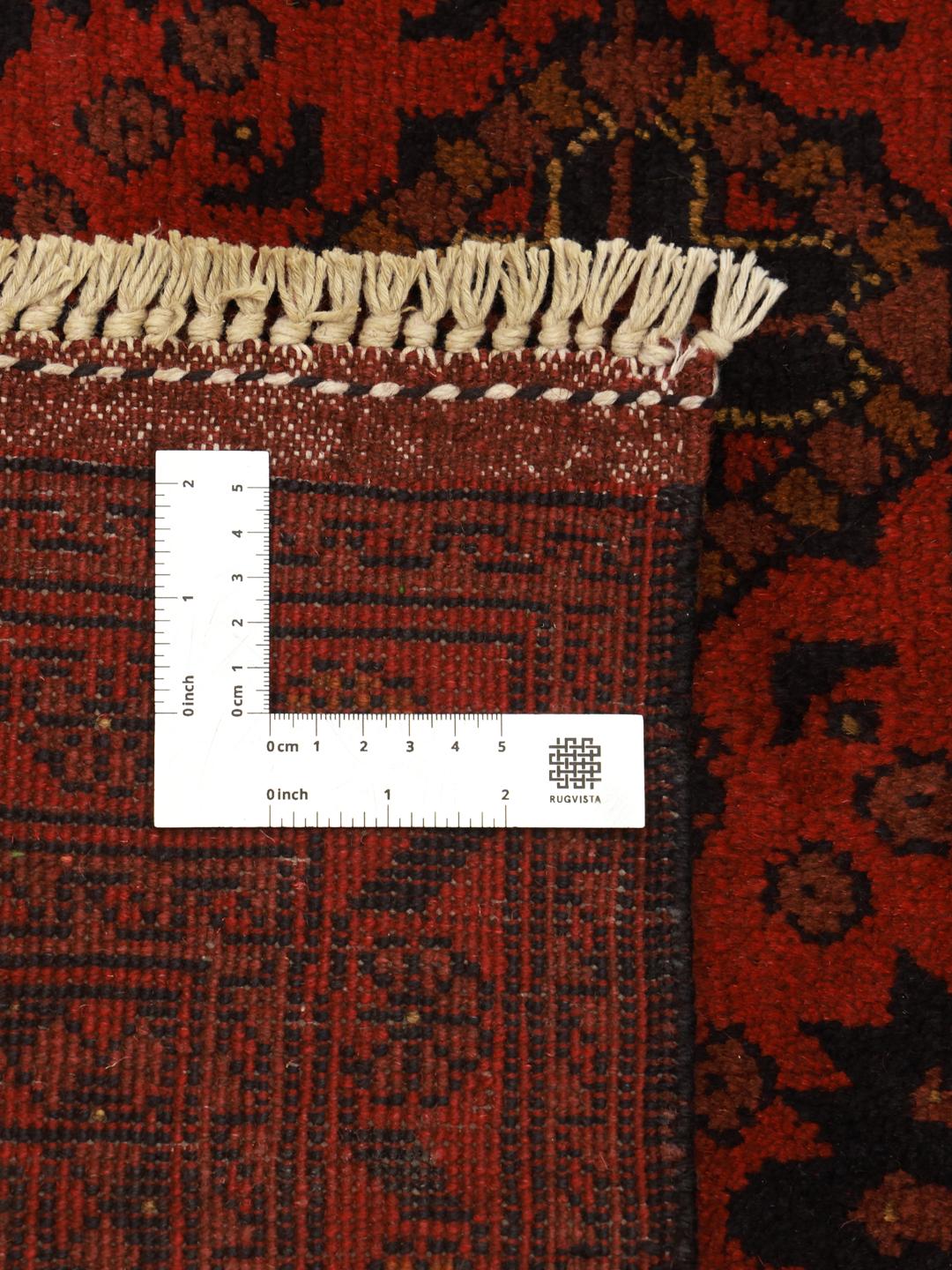 Hand-knotted Afghan Khal Mohammadi wool rug in dark-red with traditional patterns.