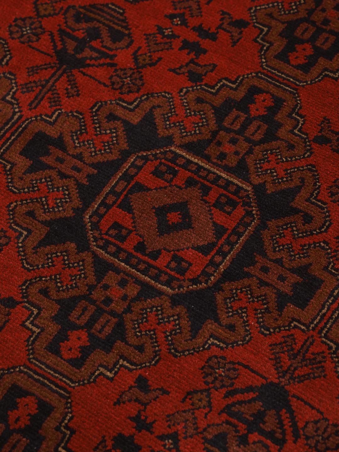 Hand-knotted Afghan Khal Mohammadi rug with a deep red field and geometric motifs