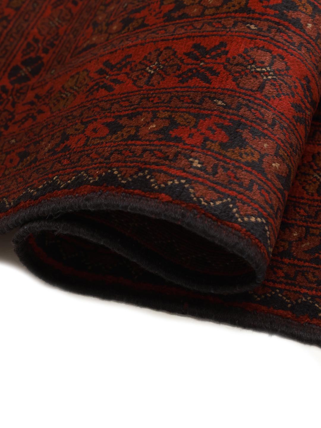 Hand-knotted Afghan Khal Mohammadi rug with a deep red field and geometric motifs