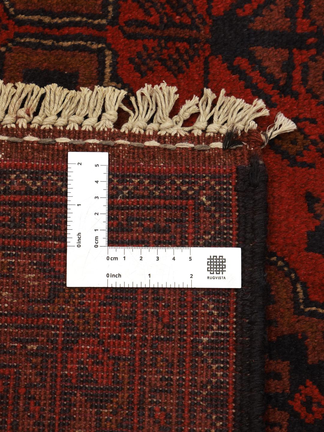 Hand-knotted Afghan Khal Mohammadi rug with a deep red field and geometric motifs