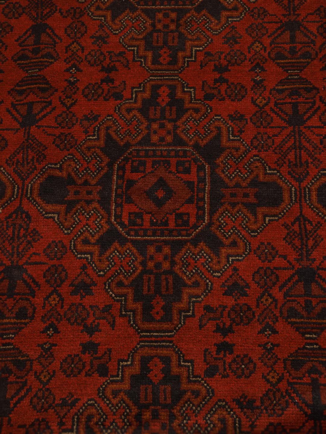 Hand-knotted Afghan Khal Mohammadi rug with a deep red field and dark geometric motifs