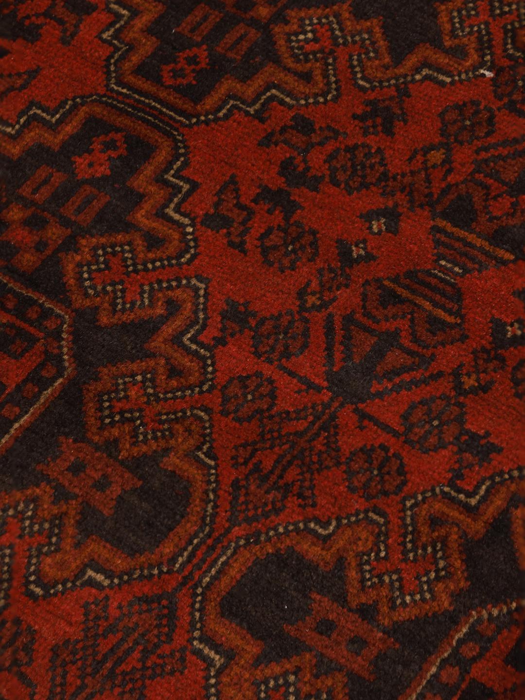 Hand-knotted Afghan Khal Mohammadi rug with a deep red field and dark geometric motifs