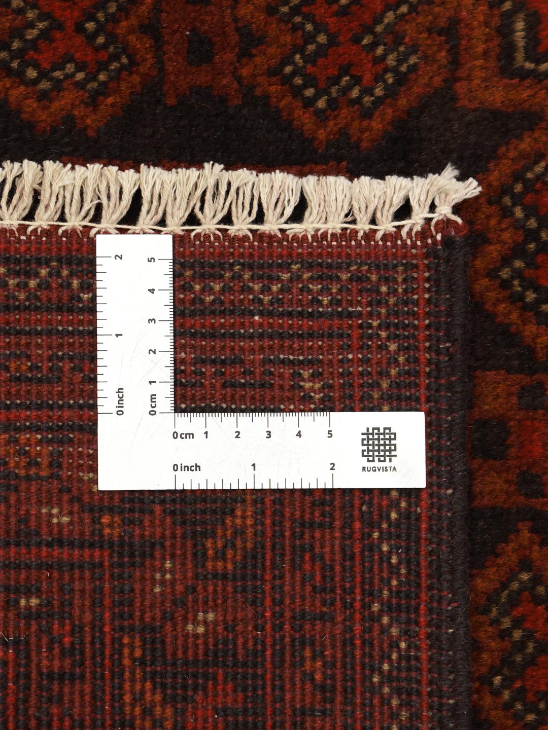Hand-knotted Afghan Khal Mohammadi rug with a deep red field and dark geometric motifs