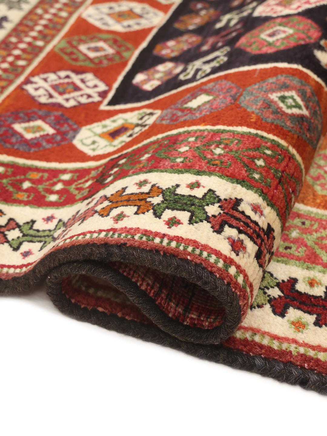 Hand-knotted Ghashghai rug from the Middle East with a dark blue and red colour palette