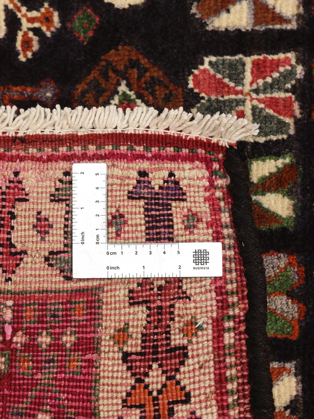 Hand-knotted Ghashghai rug from the Middle East with a dark blue and red colour palette